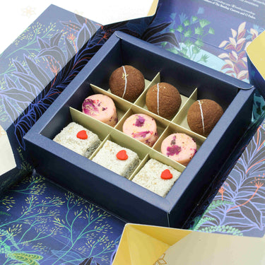 Unravel box filled with strawberries & cream pedha, salted caramel truffle pop and luxe Kaju Marzipan Bon Bon